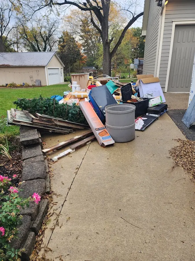 Dumpster being loaded with debris for Estate Cleanout Dumpster Rental in Rockwell